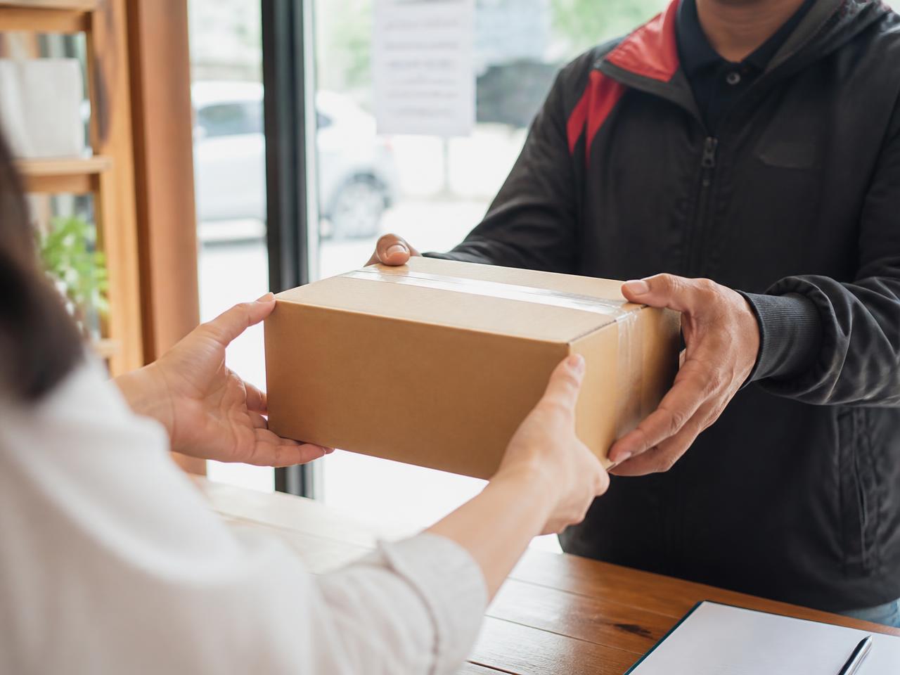 A parcel being handed to a Druppa courier